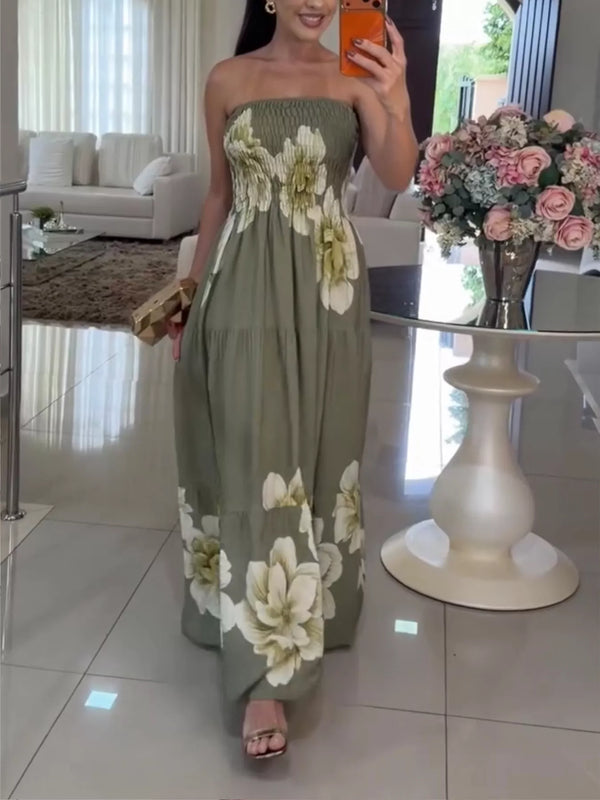 Model wearing a green floral strapless maxi dress with a tiered skirt, viewed at full length.