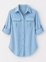 Light blue button-down shirt laid flat with collar, pocket and sleeve details