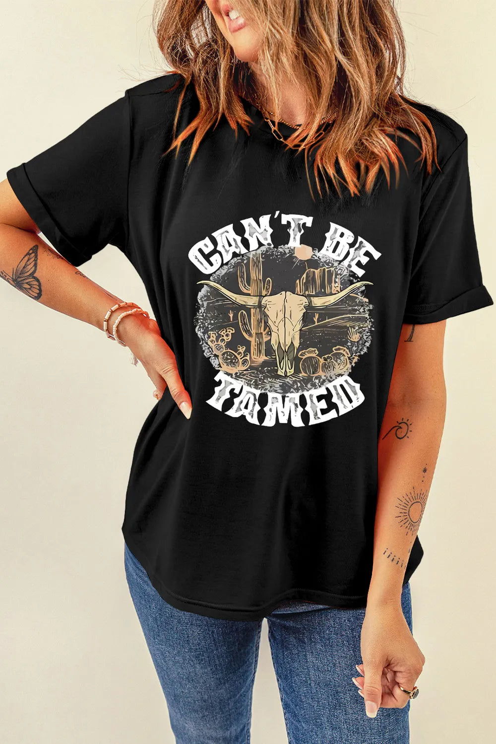 Model wearing black tee with western graphic