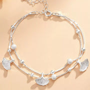 Double-layer silver ginkgo leaf bracelet arranged in a circle with bead accents