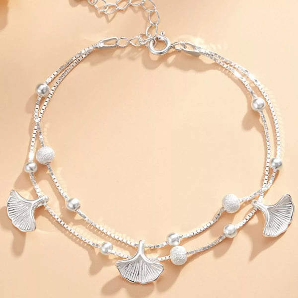 Double-layer silver ginkgo leaf bracelet arranged in a circle with bead accents