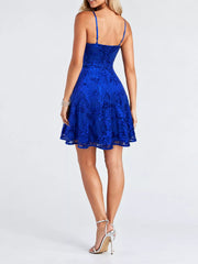 Back view of the royal blue mini dress showing adjustable straps and floral sequins.