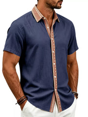 Model wearing navy shirt with patterned collar and button placket