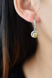 Platinum-Plated 2 Carat Moissanite Drop Earrings — Yellow-stone drop earring worn on an ear