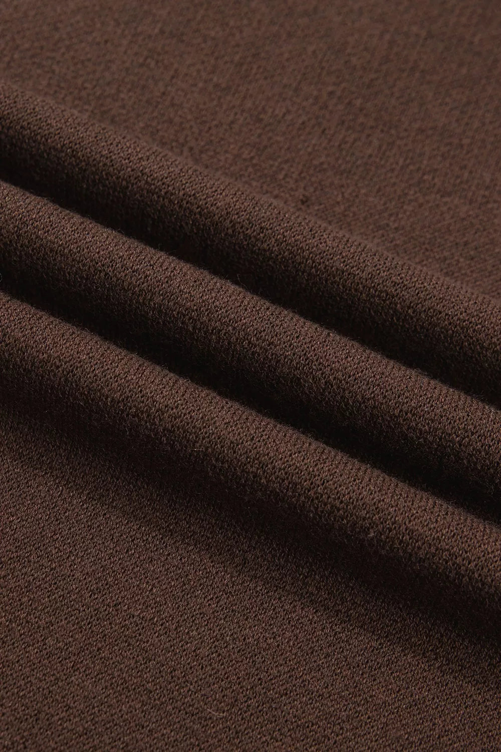 Folded brown tee fabric shown in close-up