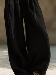 Close view of flowing black wide-leg pant legs