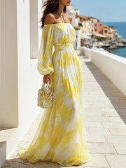 Side view of the yellow patterned dress showing its long balloon sleeve and full skirt