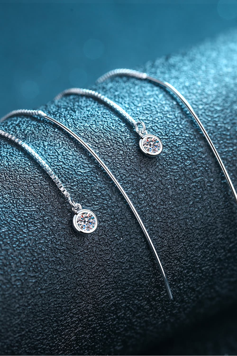 Moissanite 925 Sterling Silver Threader Earrings — Close-up of threader earrings on a blue display