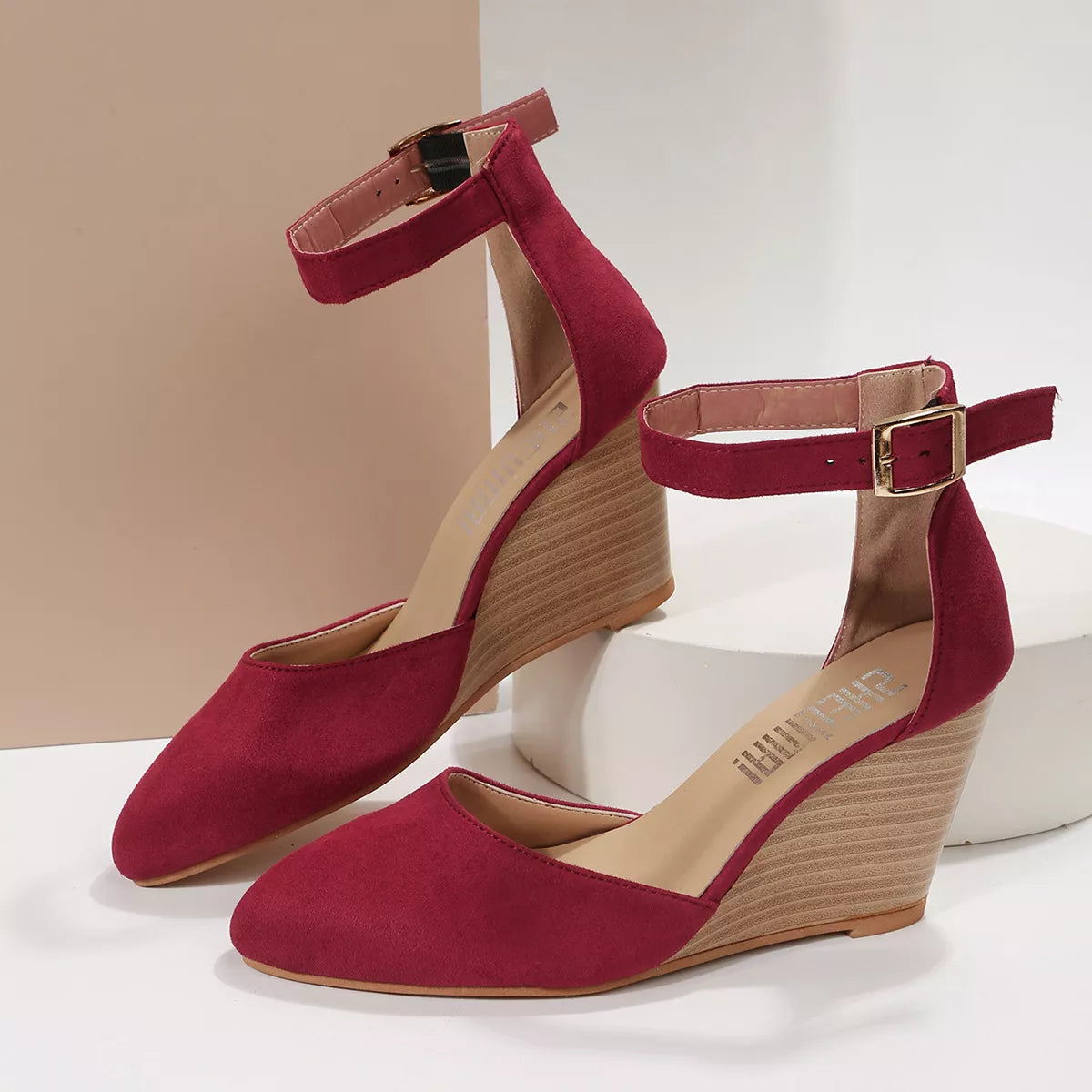 Pair of burgundy pointed-toe sandals with woven wedge heels