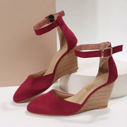 Pair of burgundy pointed-toe sandals with woven wedge heels