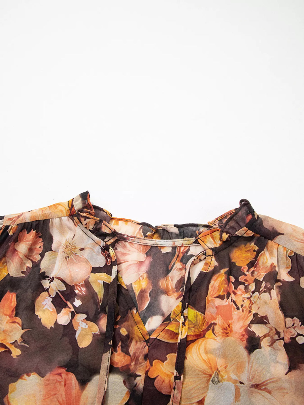 Women's floral V-neck puff-sleeve blouse, close-up of V-neck and tie detail