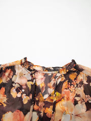 Women's floral V-neck puff-sleeve blouse, close-up of V-neck and tie detail