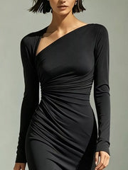 Close-up of the black dress's diagonal neckline and ruched waist.