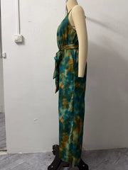 Side view of teal and tan tie-dye halter jumpsuit on a mannequin showing the waist tie and wide leg