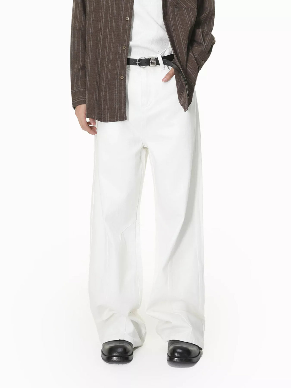 Front view of white wide-leg jeans styled with a brown shirt and black belt