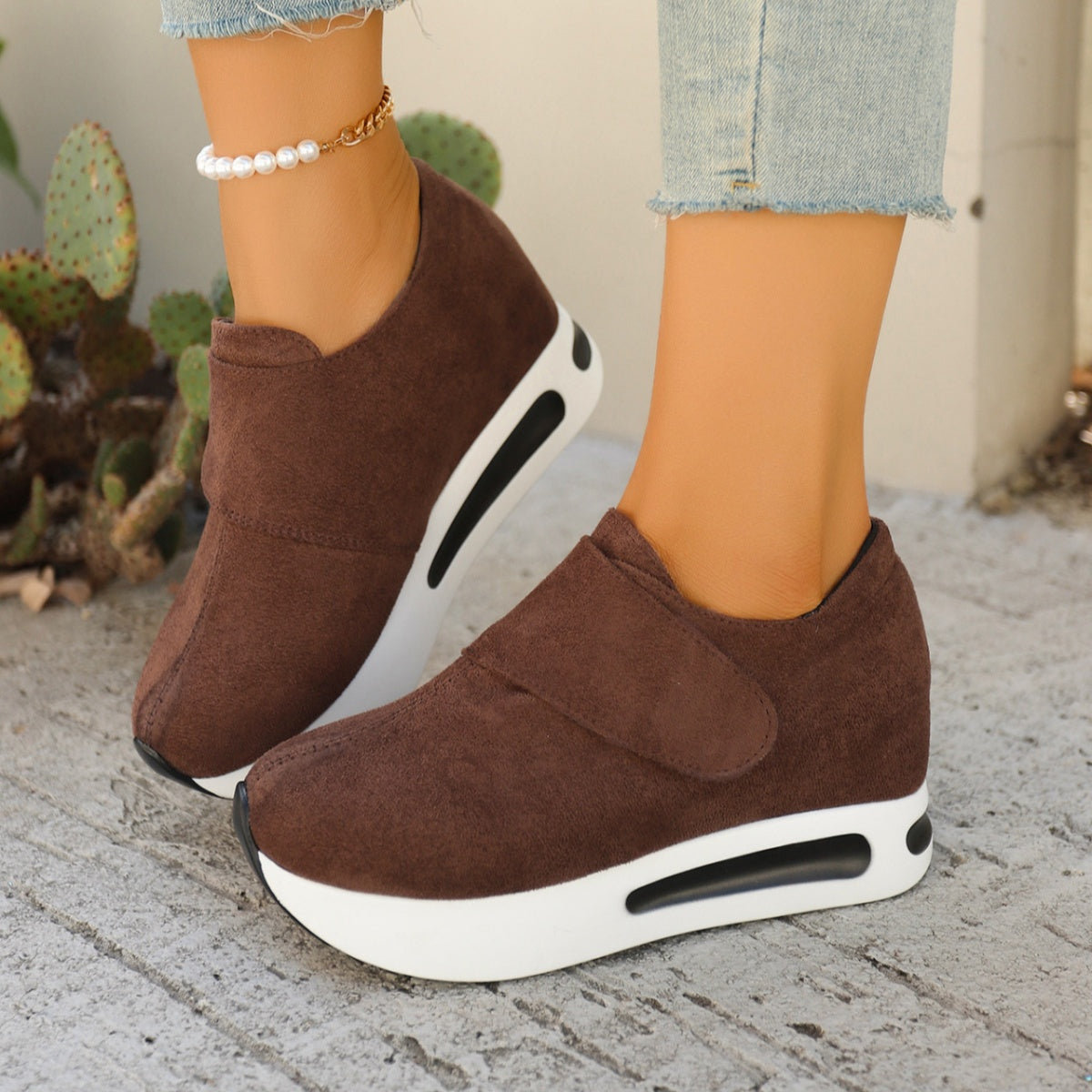 Pair of brown suede-look slip-on platform sneakers, angled view