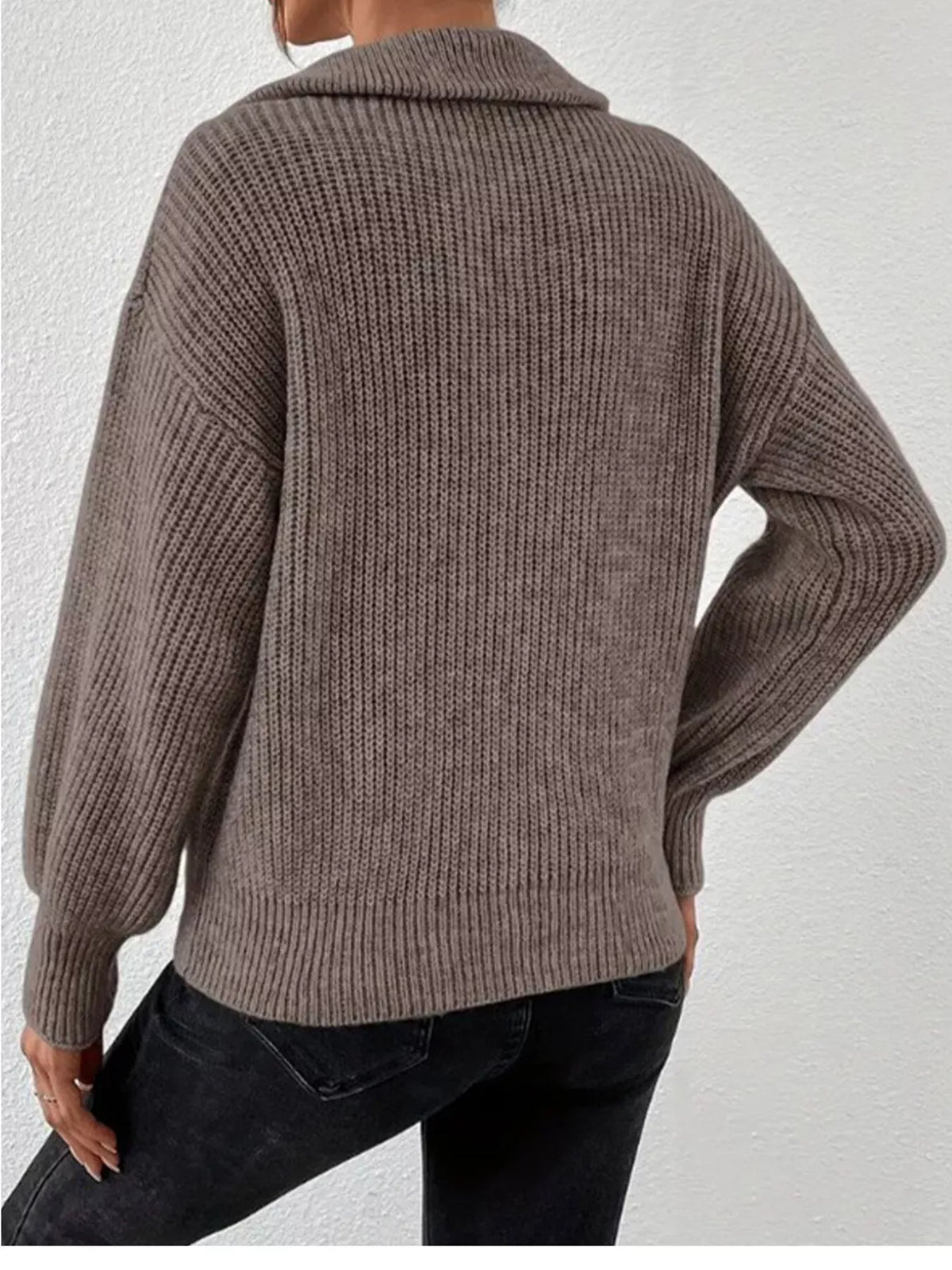 Back view of taupe ribbed sweater with dropped shoulder seams and straight hem