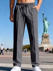 Side view of black pants styled with a light overshirt.