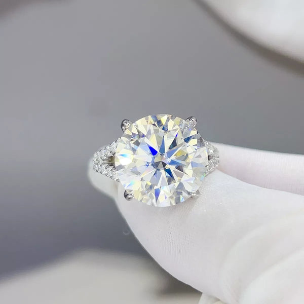 Close-up of the round moissanite center stone and embellished band on the ring