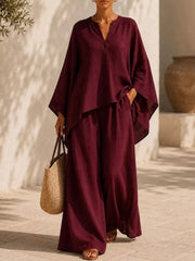 Woman modeling the burgundy notched top and matching wide-leg pants, full-length view.