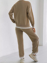 Back view of the taupe knit set showing white edging at the sweater hem, cuffs and trouser hems.