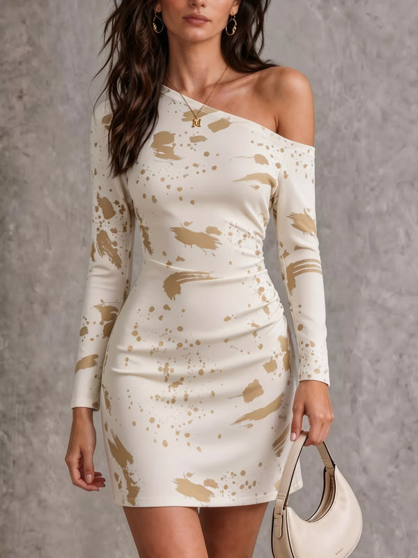 Model wearing a cream one-shoulder long-sleeve mini dress with beige paint-splatter accents