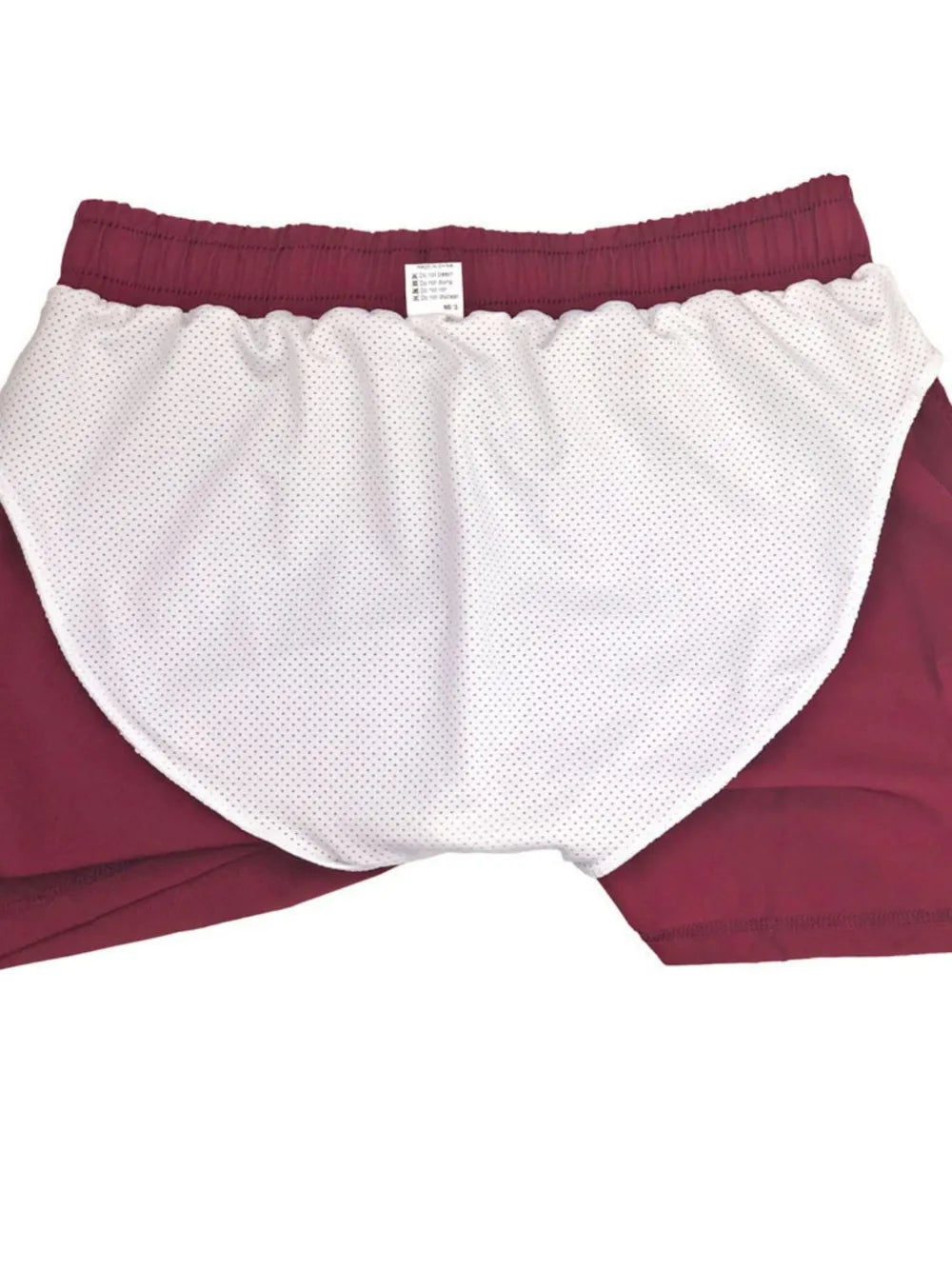 White and burgundy color-block athletic shorts, flat lay