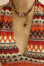 Close-up of orange and brown geometric-print deep V neckline
