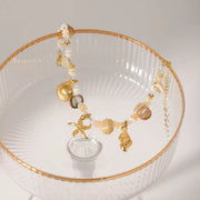 Gold shell charm bracelet laid flat