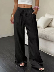Women's wide-leg pants with drawstring waist and pockets, close-up