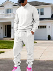 White cable-knit mock-neck sweater and joggers worn front-facing.