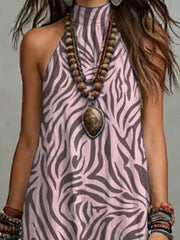 Close view of the mauve zebra-like print and halter neckline on the maxi dress.