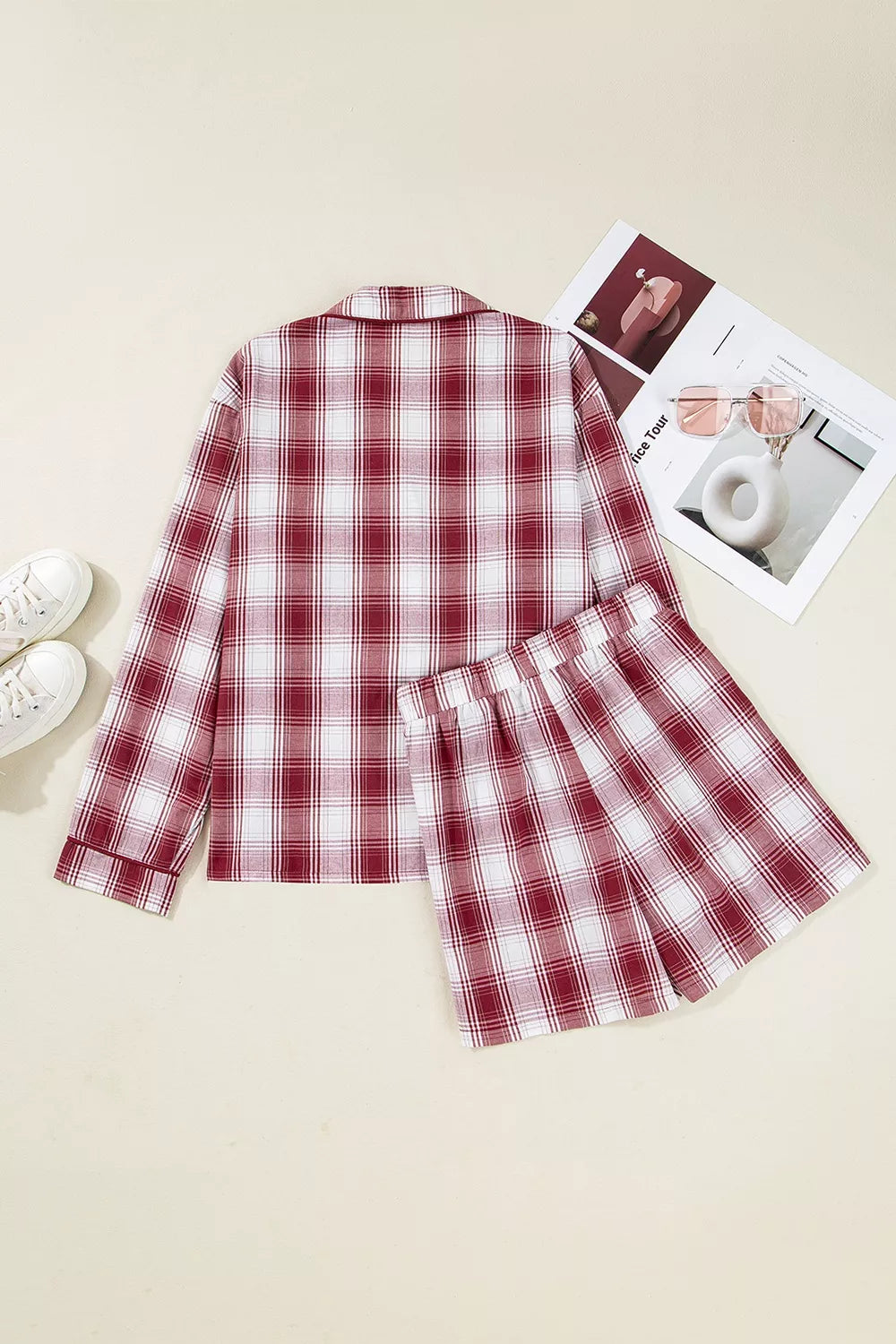 Model wearing red plaid pajama shirt and shorts, front pose