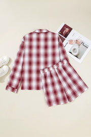 Model wearing red plaid pajama shirt and shorts, front pose
