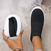 Black mesh sneakers shown from above and below