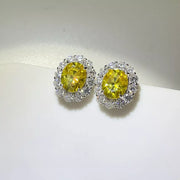 Close-up of the yellow centre stones and clear halo settings on the earrings.