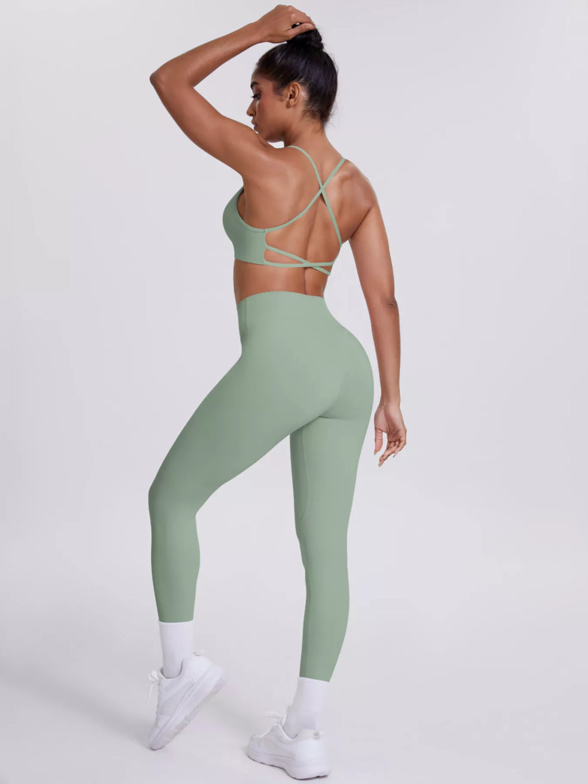 Close view of garment details of criss-cross back cami and leggings active set