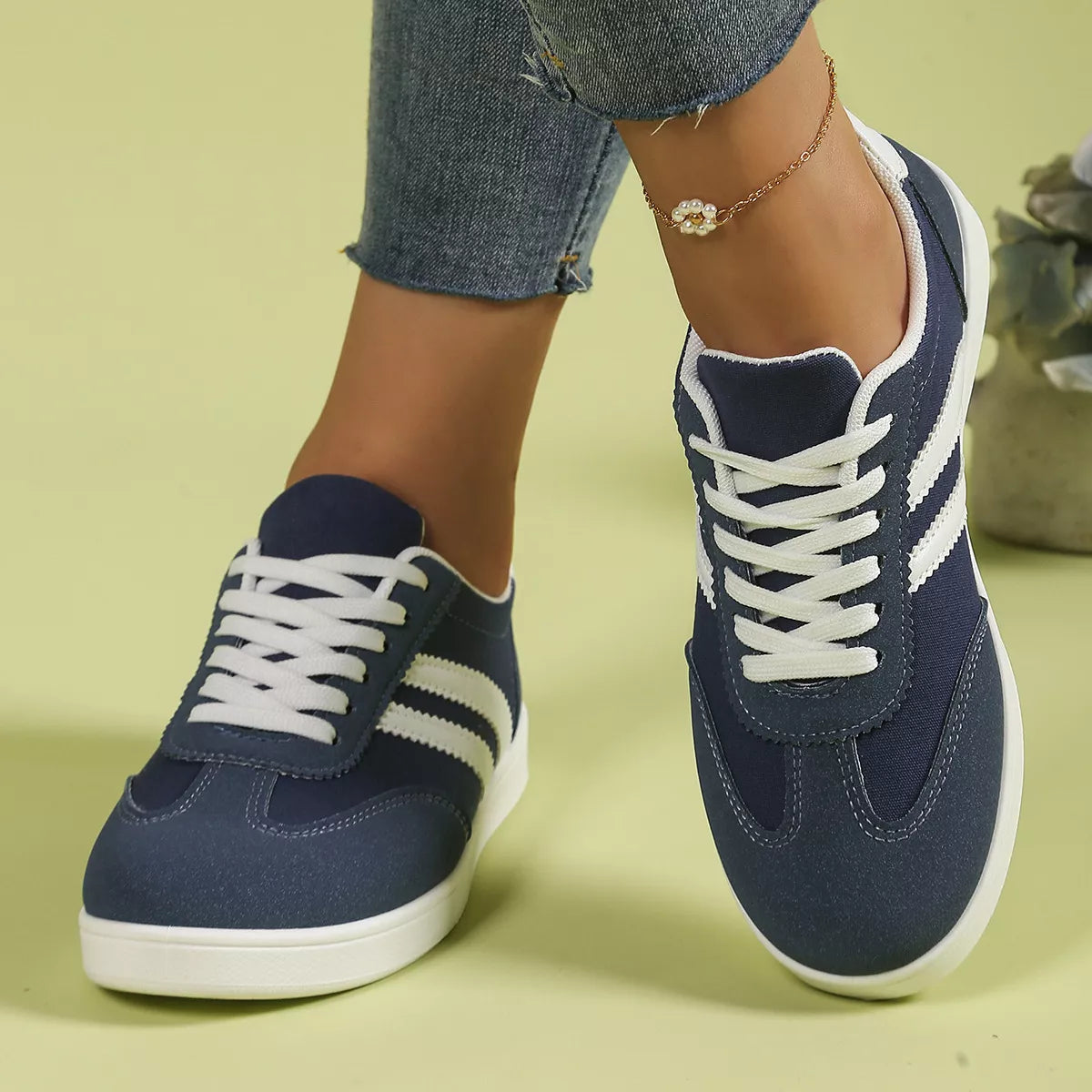 Navy striped flats worn with jeans, viewed from above