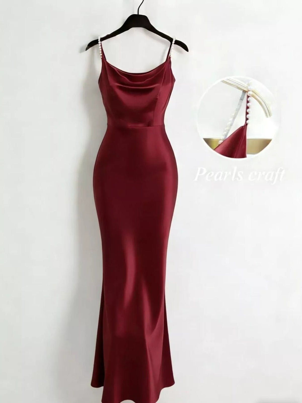 Burgundy satin cowl-neck maxi dress with pearl straps on a hanger.