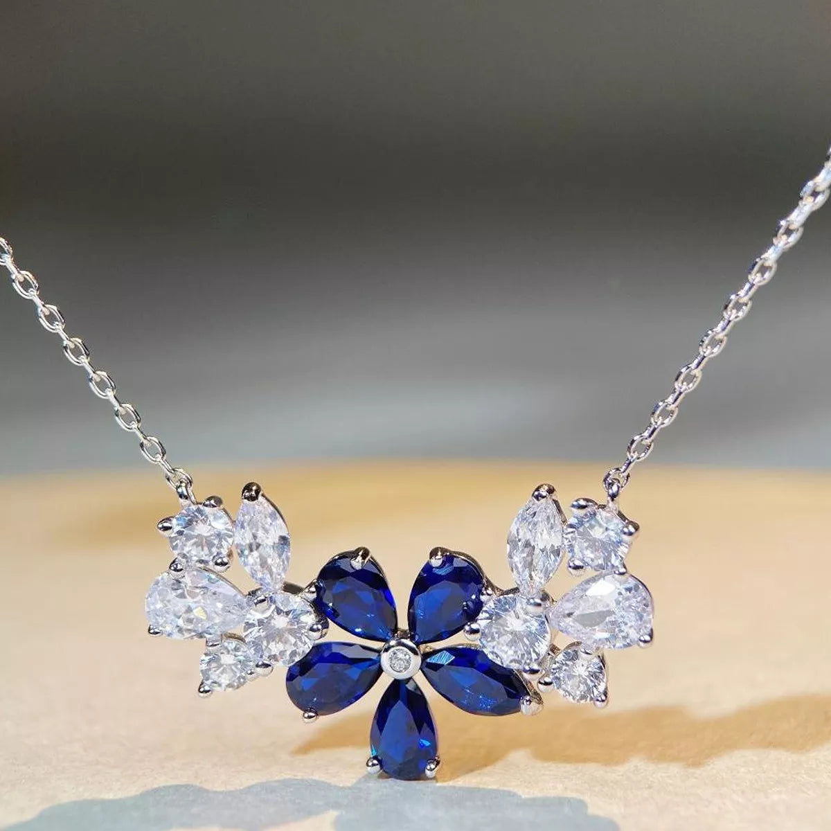 Silver-tone flower necklace with blue center stones