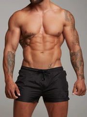 Model wearing black drawstring active shorts, full view