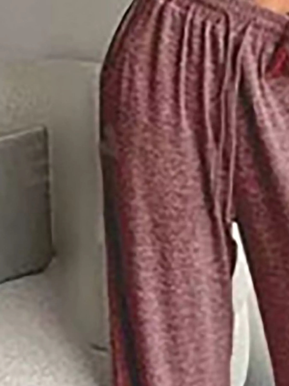 Close-up of rose-coloured pants showing gathered elastic waist and drawstring ends