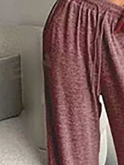 Close-up of rose-coloured pants showing gathered elastic waist and drawstring ends