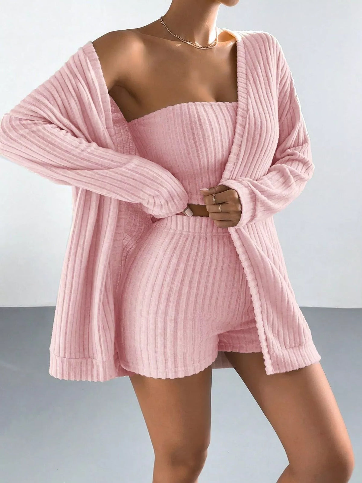 Pink ribbed three-piece lounge set with open cardigan, tube top and shorts
