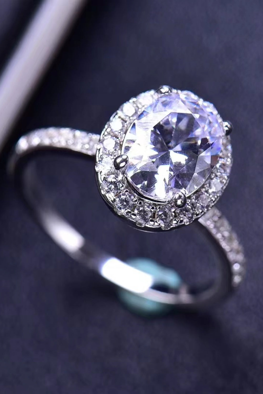 Angled view of platinum-plated oval moissanite ring