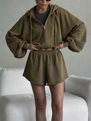 Olive zip hoodie and shorts shown from the front with dark shirt