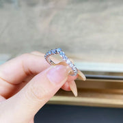 Angled view of the slim V-shaped stone-set ring.