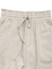 Close-up of gathered drawstring waist and frill trim