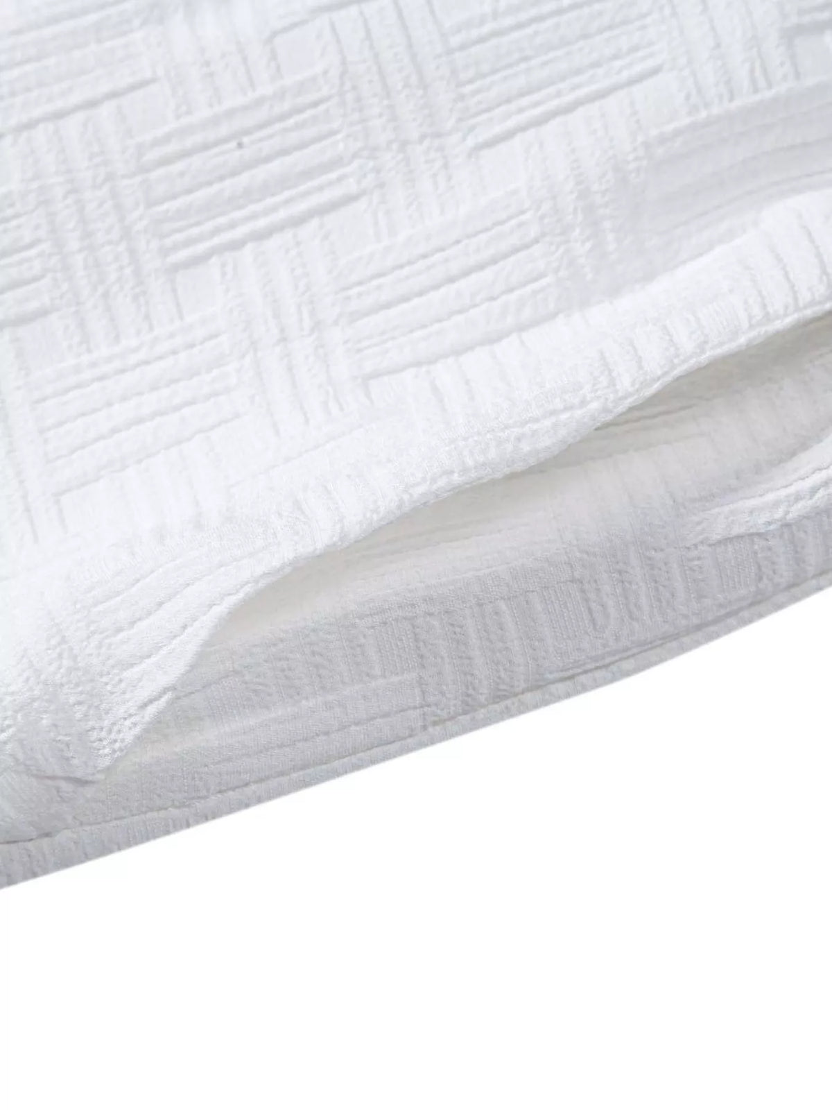 Close-up of subtle raised linear texture in white shorts fabric