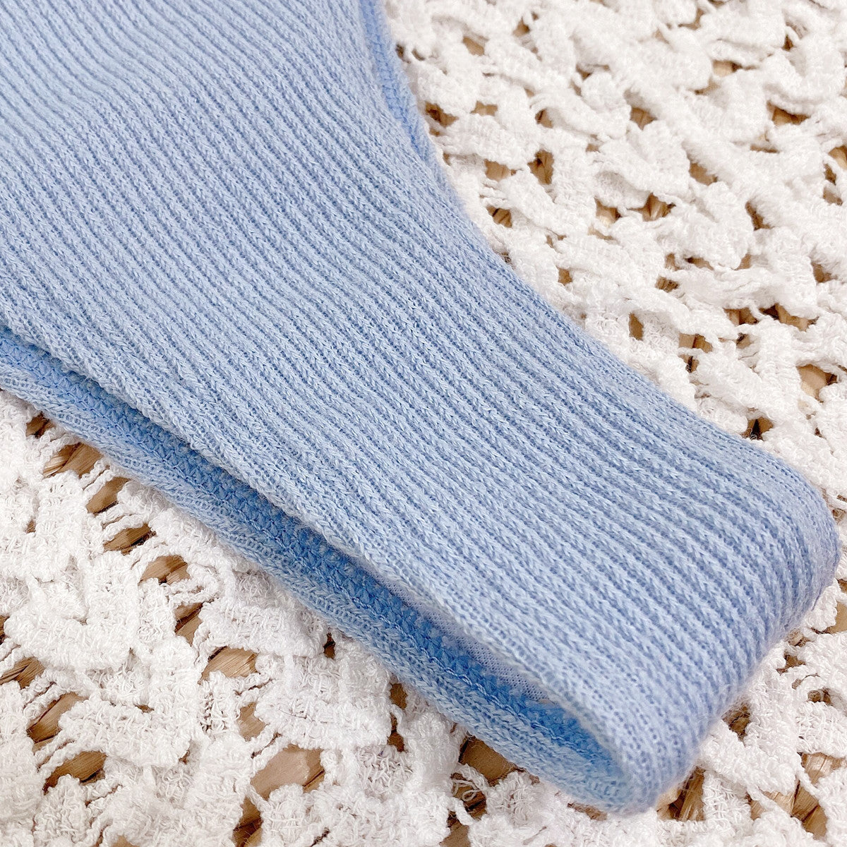 Close-up of light blue ribbed bikini fabric texture